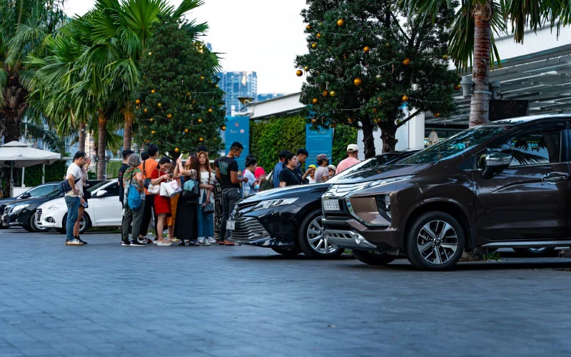 A luxury coach arriving at Alton Tower Resorts with excited families stepping off.