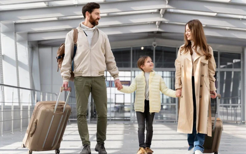 Family arriving at a cozy hotel near Alton Towers with luggage and smiles.