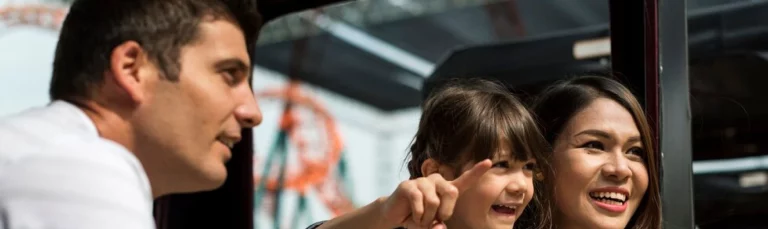 A happy family boarding a coach headed to Alton Towers Resort, ready for a thrilling theme park adventure. Alton Towers admission