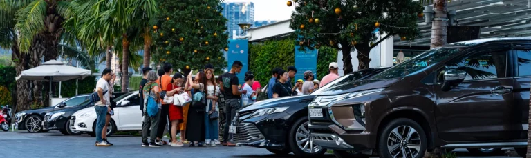 A luxury coach arriving at Alton Tower Resorts with excited families stepping off.