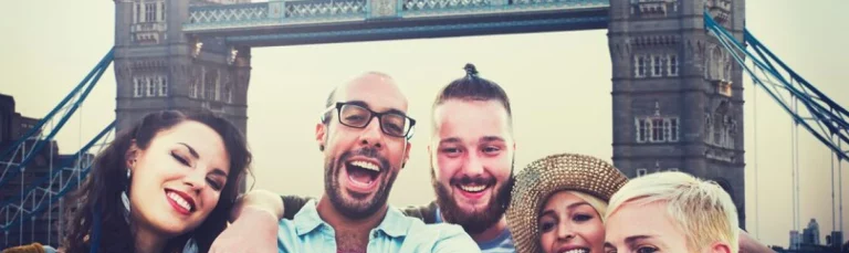 Happy tourists enjoying a scenic bus ride in London with The London Coach Company. bus trip in London