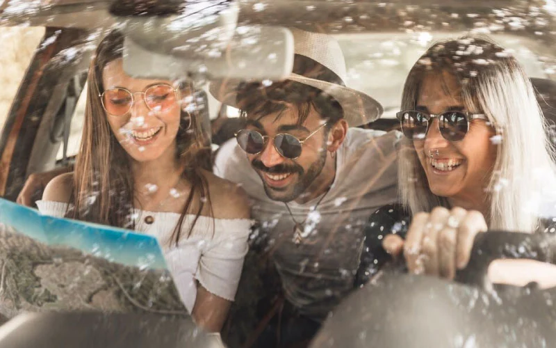 Wedding guests smiling while boarding a group minibus hire vehicle in London.