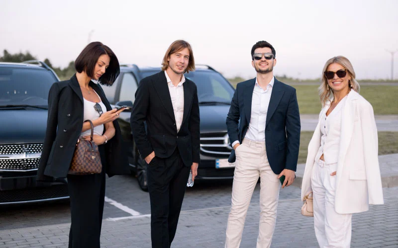 Business group boarding a private shuttle at a London event venue.