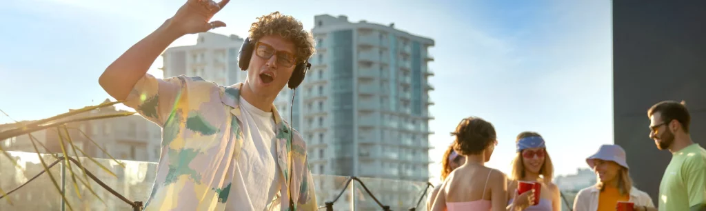 Festival crowd enjoying live music at All Points East in Victoria Park with stage lights and summer skies, Coach hire with driver