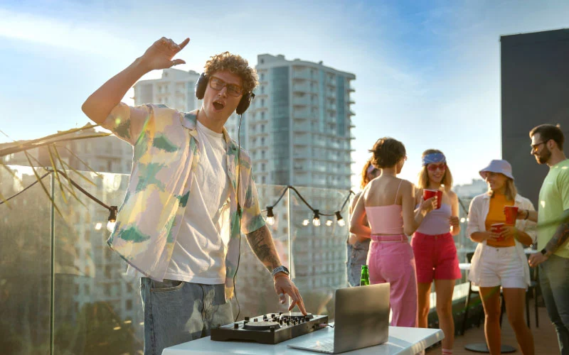 Festival crowd enjoying live music at All Points East in Victoria Park with stage lights and summer skies
